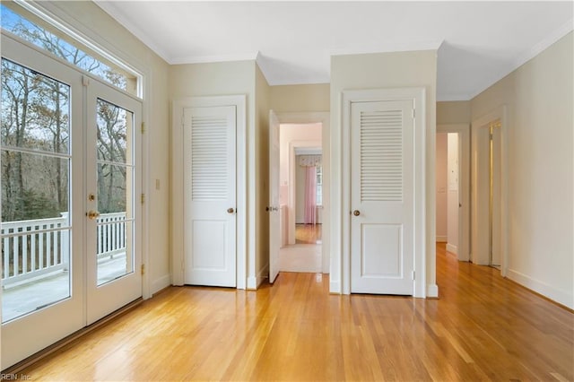 doorway featuring french doors, light hardwood / wood-style flooring, and crown molding