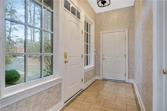 doorway featuring a notable chandelier