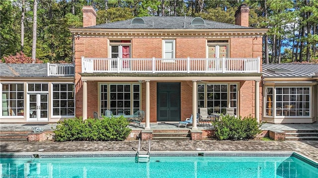 back of house with a balcony