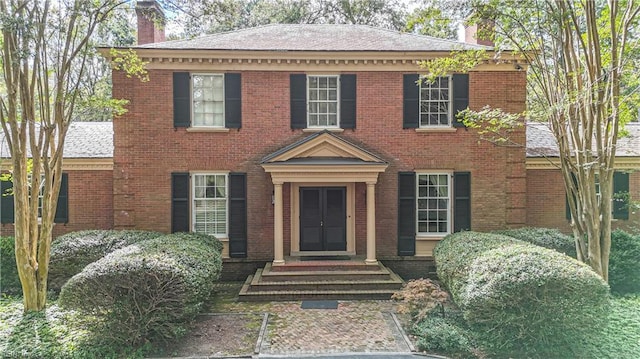 colonial house featuring french doors