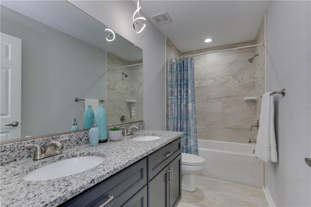 full bathroom featuring shower / bath combo, vanity, and toilet