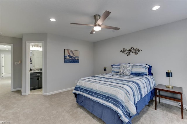 bedroom featuring ensuite bathroom, ceiling fan, and light colored carpet