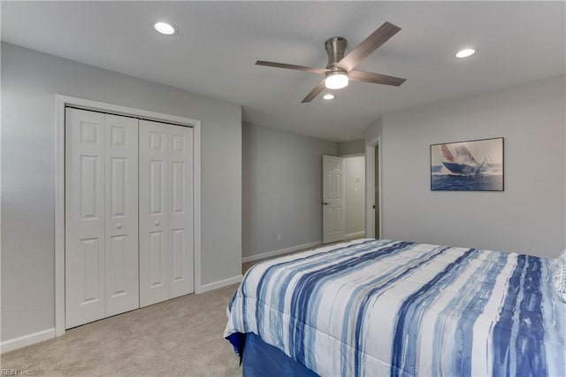 carpeted bedroom featuring ceiling fan and a closet