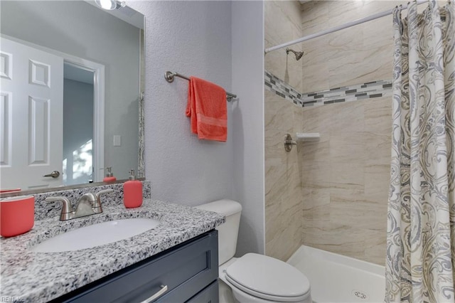 bathroom with toilet, vanity, and a shower with shower curtain