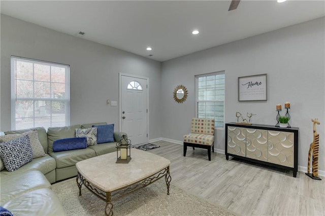 living room with ceiling fan and light wood-type flooring