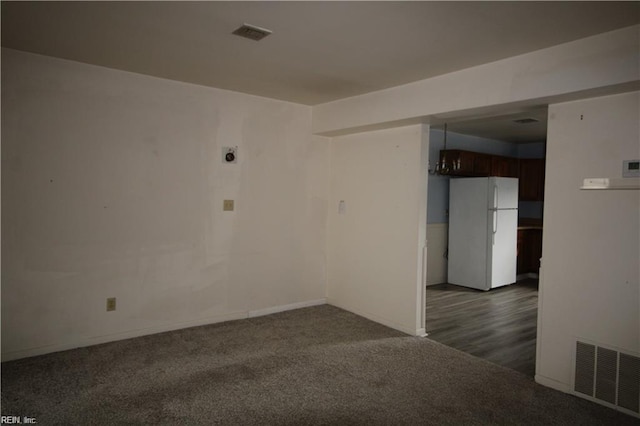 empty room with dark colored carpet