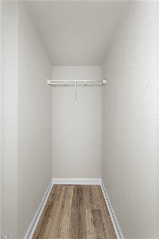 spacious closet featuring hardwood / wood-style floors