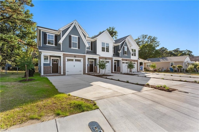 view of front of house featuring a garage and a front lawn