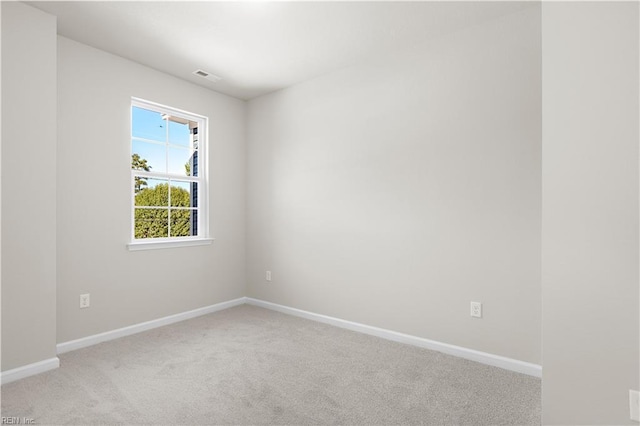 unfurnished room with light colored carpet