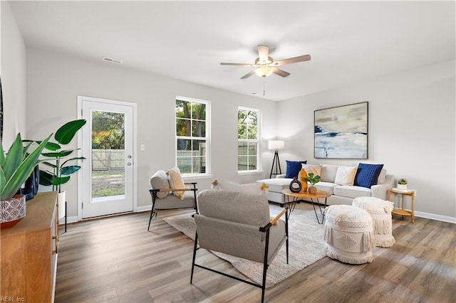 living room featuring ceiling fan and hardwood / wood-style floors