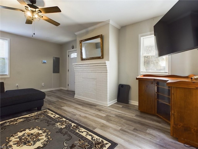 living room featuring hardwood / wood-style flooring, ceiling fan, and a healthy amount of sunlight