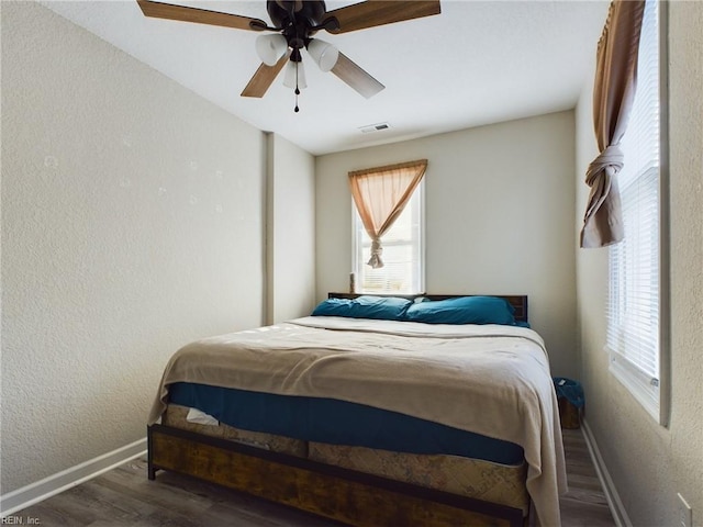 bedroom with ceiling fan and dark hardwood / wood-style floors