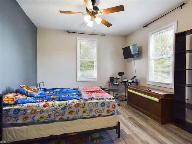 bedroom featuring ceiling fan and light hardwood / wood-style flooring