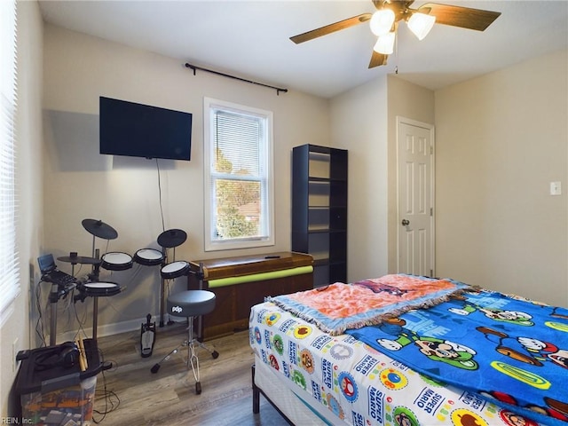 bedroom featuring ceiling fan and hardwood / wood-style floors