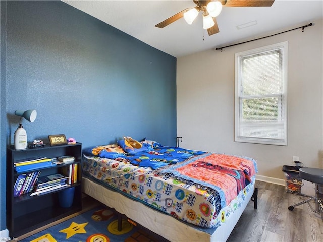 bedroom featuring dark hardwood / wood-style flooring and ceiling fan