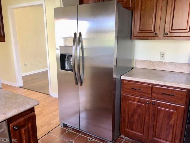 kitchen with appliances with stainless steel finishes and hardwood / wood-style flooring