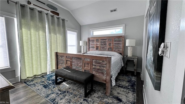 bedroom with lofted ceiling and dark wood-type flooring