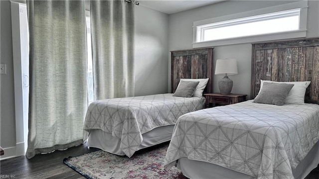 bedroom with dark hardwood / wood-style floors