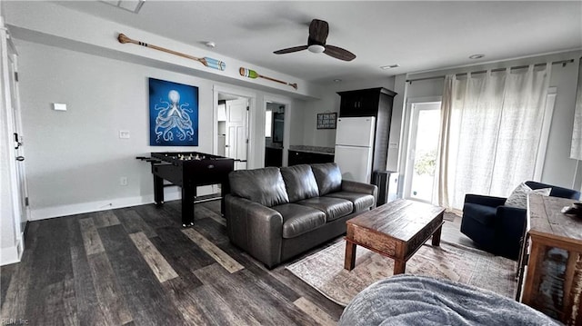 living room featuring ceiling fan and dark hardwood / wood-style flooring