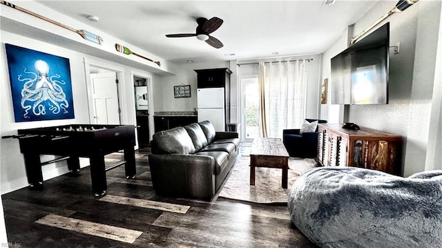 living room featuring dark hardwood / wood-style flooring and ceiling fan