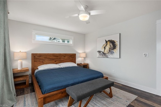 bedroom with dark hardwood / wood-style flooring and ceiling fan