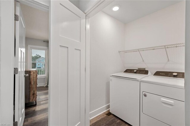 laundry room with dark hardwood / wood-style floors and washing machine and dryer