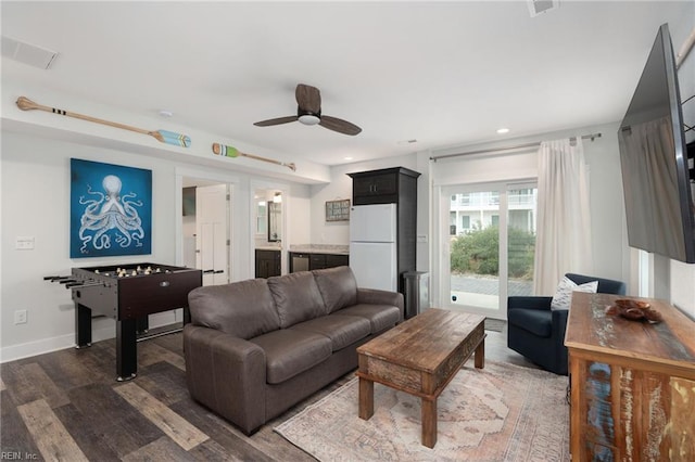 living room with dark hardwood / wood-style floors and ceiling fan