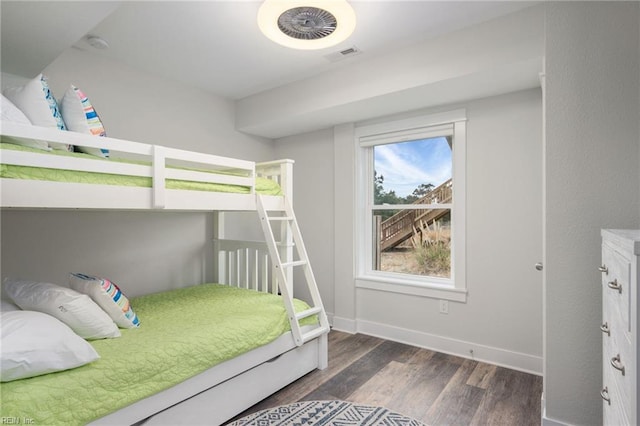 bedroom with dark wood-type flooring