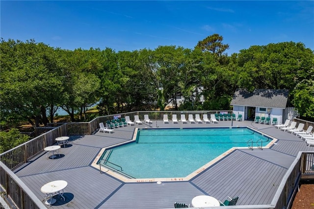 view of swimming pool featuring a patio area and an outdoor structure