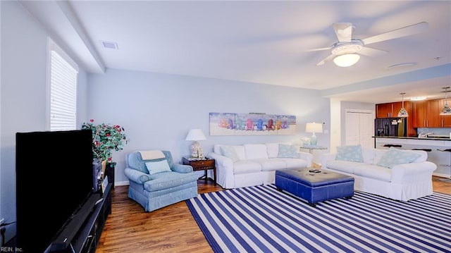 living room featuring ceiling fan and wood-type flooring