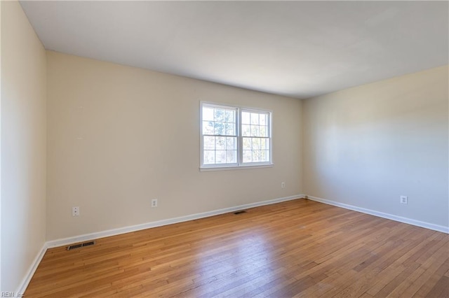 unfurnished room with light hardwood / wood-style flooring