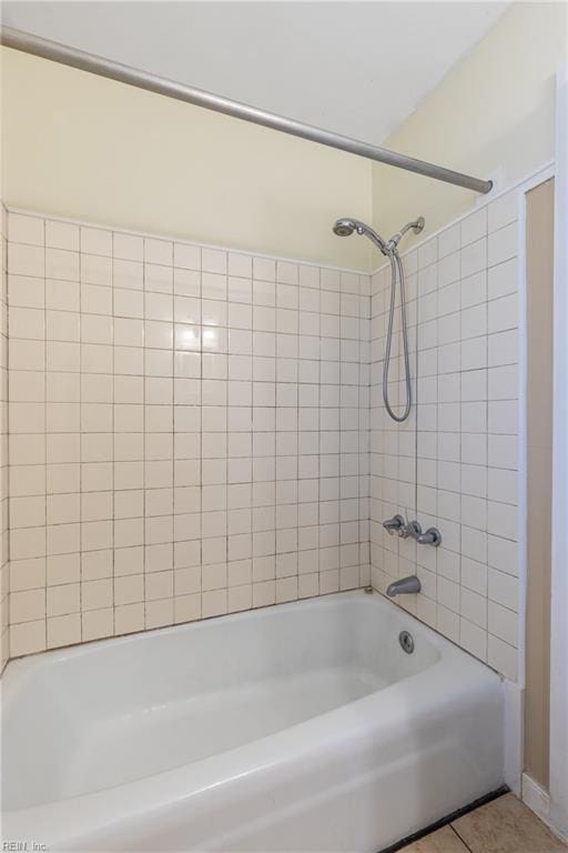 bathroom featuring tile patterned flooring and tiled shower / bath combo