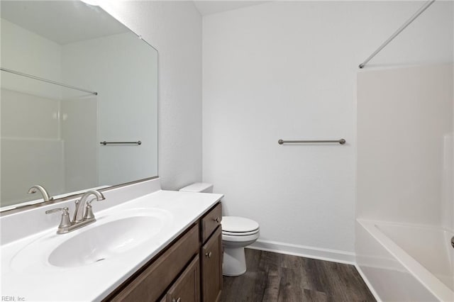 full bathroom with hardwood / wood-style floors, vanity, toilet, and bathing tub / shower combination