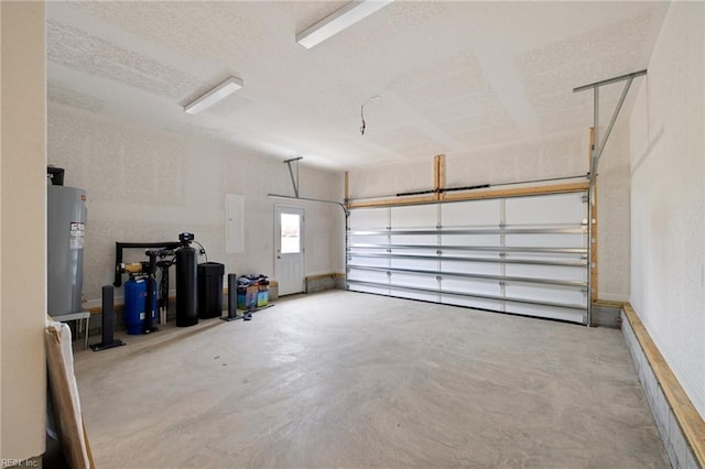 garage featuring electric panel and electric water heater