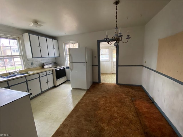 86 Cavalier Rd, Hampton, VA 23669 - kitchen with white appliances, a chandelier, light floors, light countertops, and white cabinets