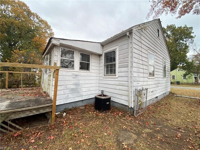 view of side of home featuring central air condition unit and a wooden deck