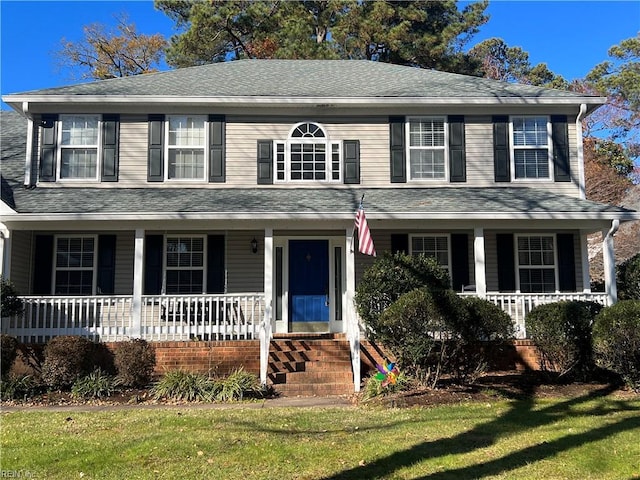 colonial house with a porch and a front lawn