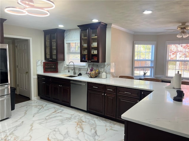 kitchen with hanging light fixtures, stainless steel dishwasher, plenty of natural light, and sink