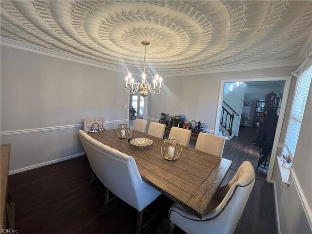 dining space featuring a chandelier, dark hardwood / wood-style floors, a raised ceiling, and crown molding