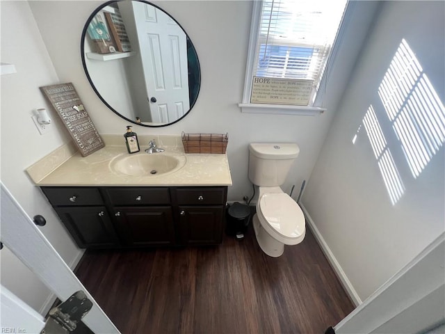 bathroom featuring vanity, toilet, and wood-type flooring