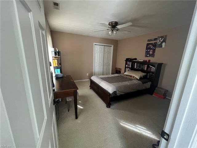 carpeted bedroom featuring a closet and ceiling fan