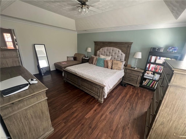 bedroom featuring a raised ceiling, ceiling fan, dark wood-type flooring, and ornamental molding