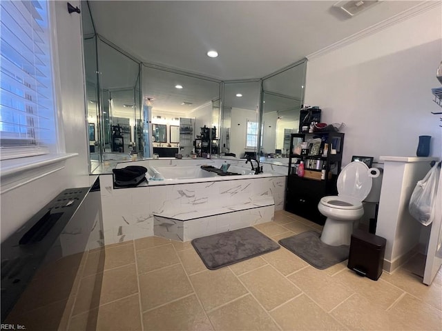 bathroom with tile patterned floors, toilet, crown molding, and tiled bath