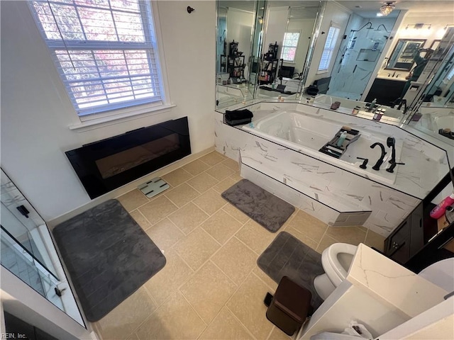 full bathroom with vanity, toilet, a wealth of natural light, and independent shower and bath