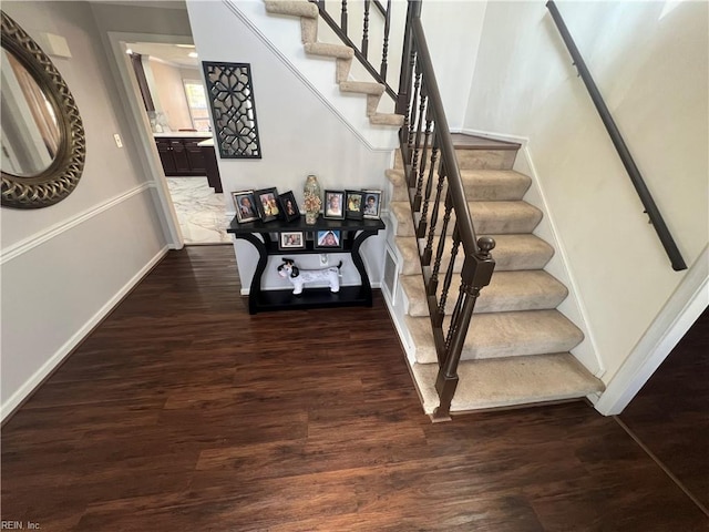 stairway with hardwood / wood-style floors