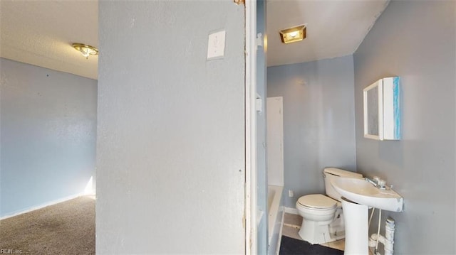 bathroom with a bathing tub and toilet