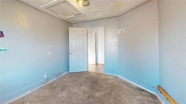 spare room with carpet floors and a textured ceiling