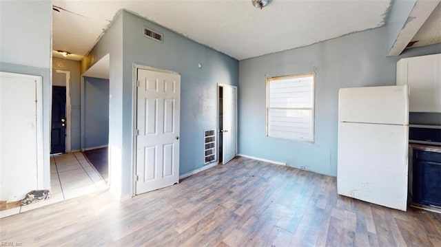 kitchen featuring light hardwood / wood-style flooring and white refrigerator