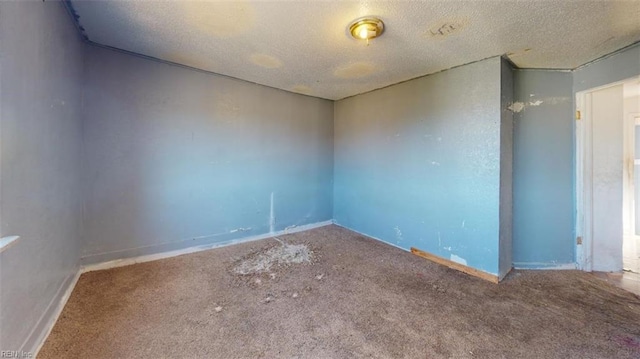 empty room featuring carpet flooring and a textured ceiling