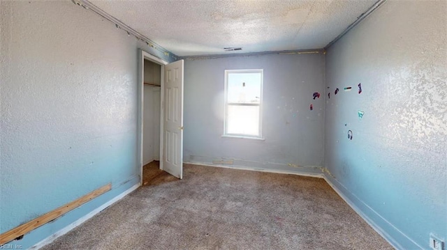 unfurnished bedroom with light carpet and a textured ceiling